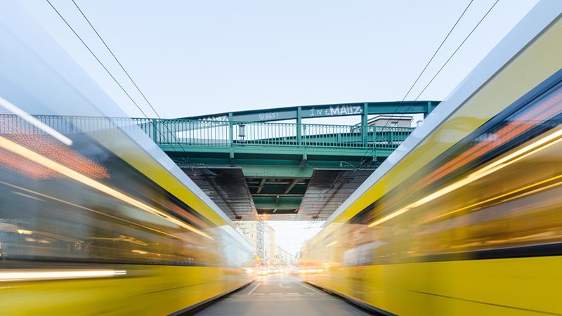 Blurred motion yellow railway trains with an intelligent transport system parallel to each other at a railroad station