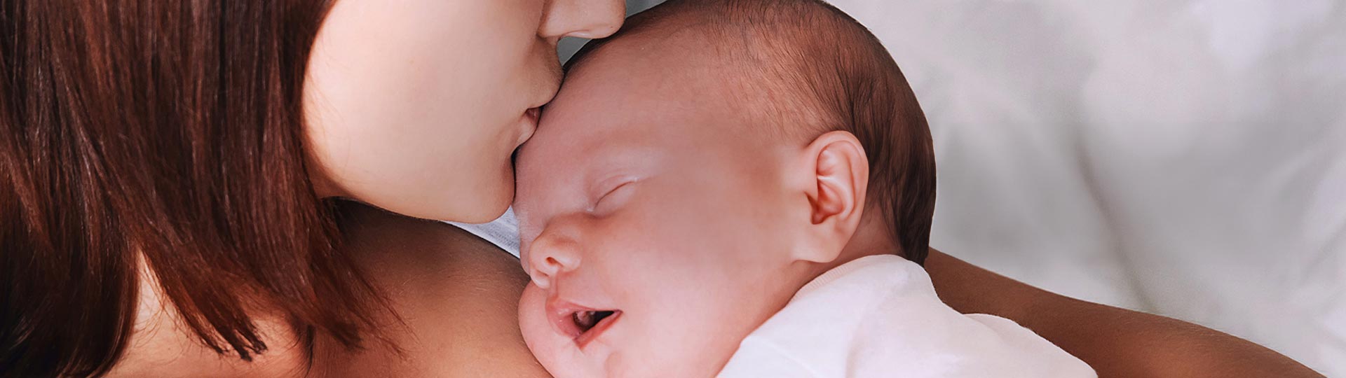 A person kissing a baby