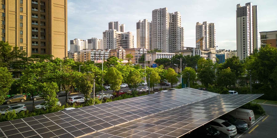 A solar panel in front of a city