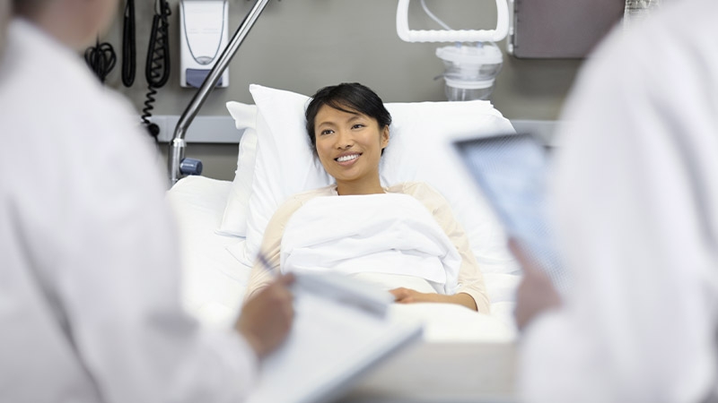 A person lying in a hospital bed