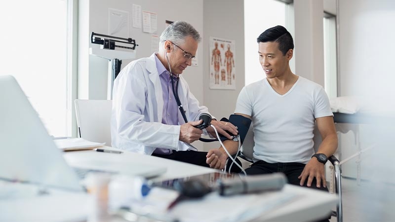 A doctor checking a patient's blood pressure