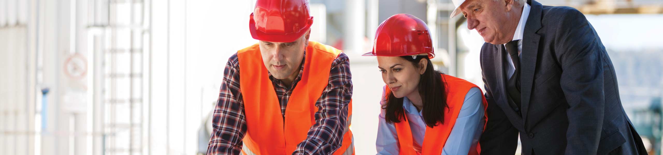 Group of industrial engineers with computer outdoor