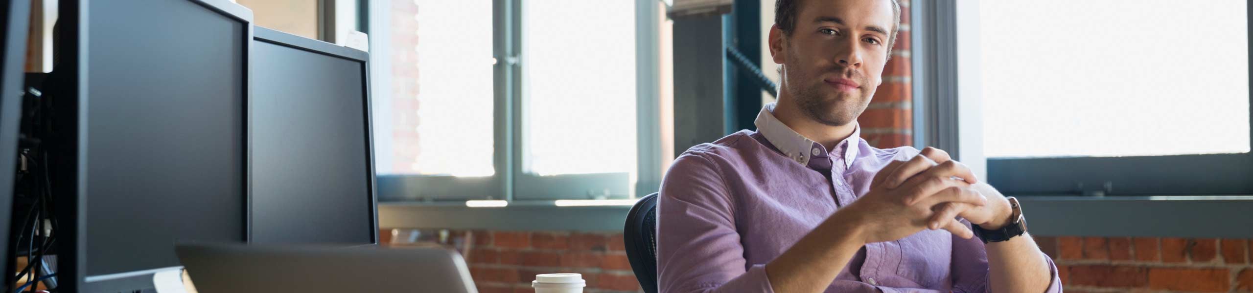 Portrait confident businessman at office desk