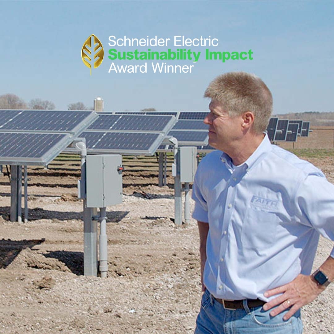 A person standing in a field of solar panels