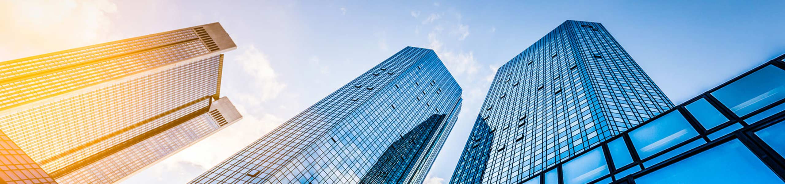 Ants eye view looking up at multiple commerical skyscrapers