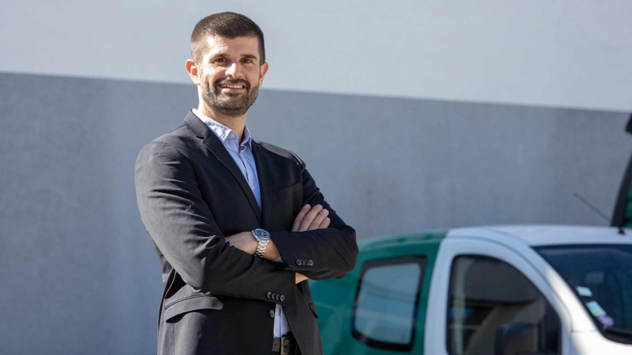 a businessman smiling and standing with hands crossed