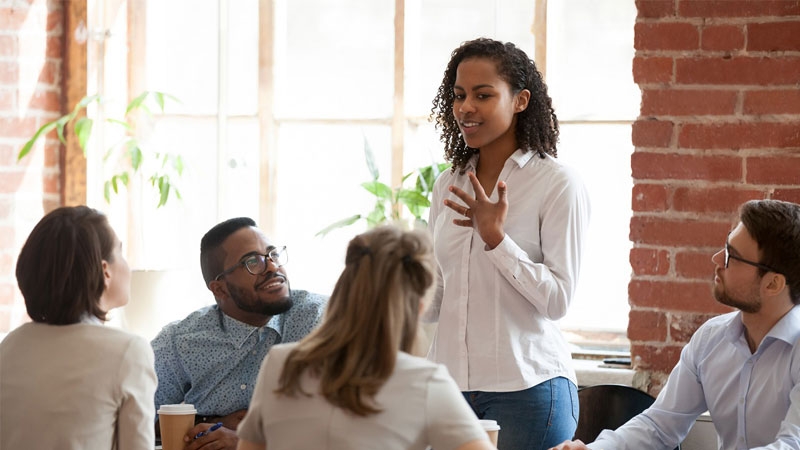 A female employee discussing with other team members