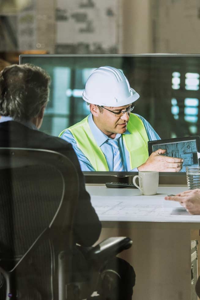 Architects and project manager in a video conference meeting with engineer