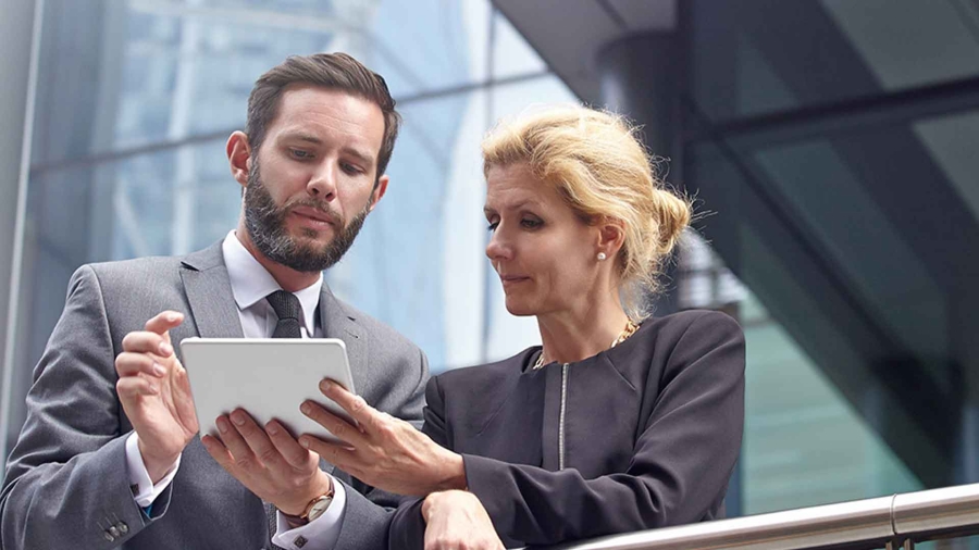 2 businessperson discuss while standing in office