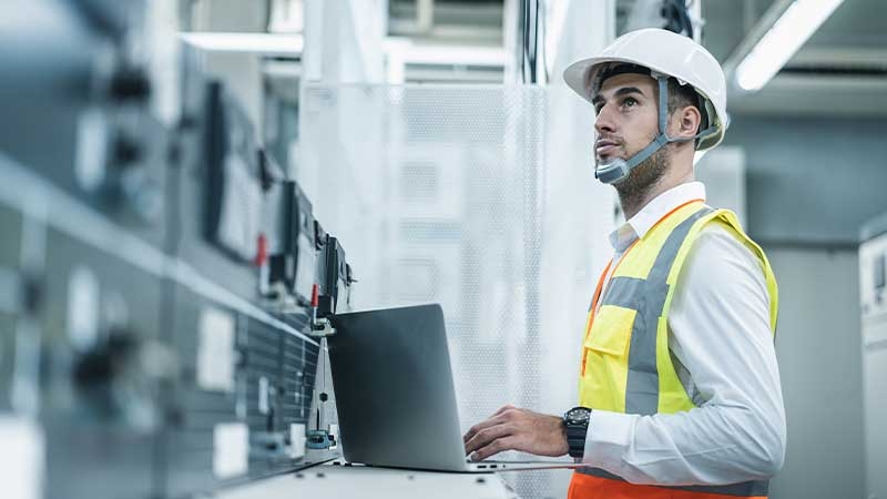 Engineer checking status of energy distribution to ensure efficient operations