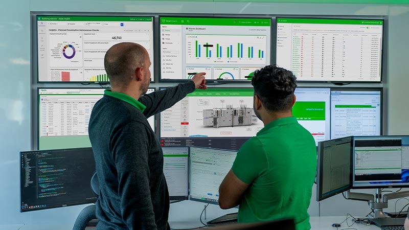 A group of men looking at a computer screen