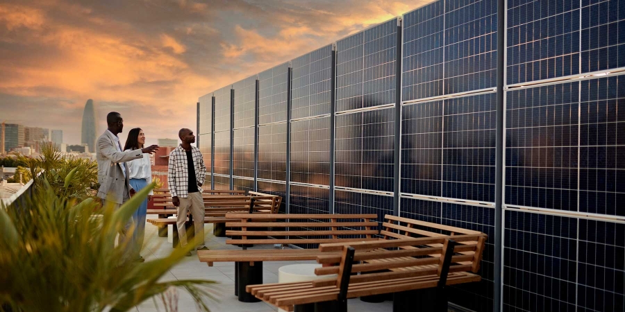 A person standing next to a solar panel