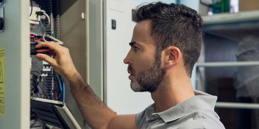 man working on electrical circuits