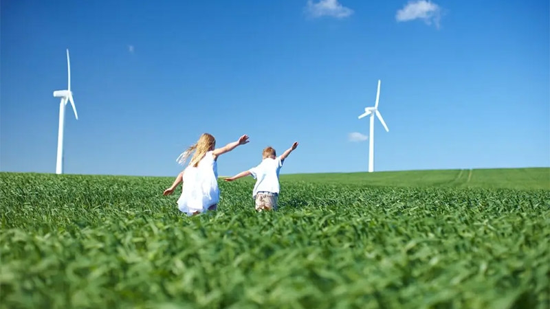 A couple of children running in a field