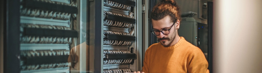 Male IT technician in server room