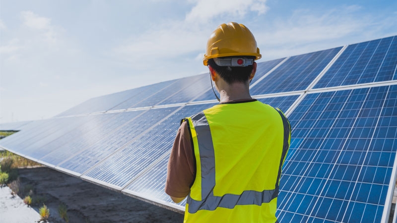 One male engineer checking the solar panel with digital tools