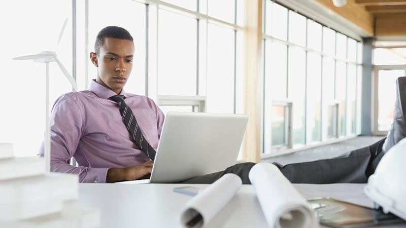 A person sitting at a desk using a computer