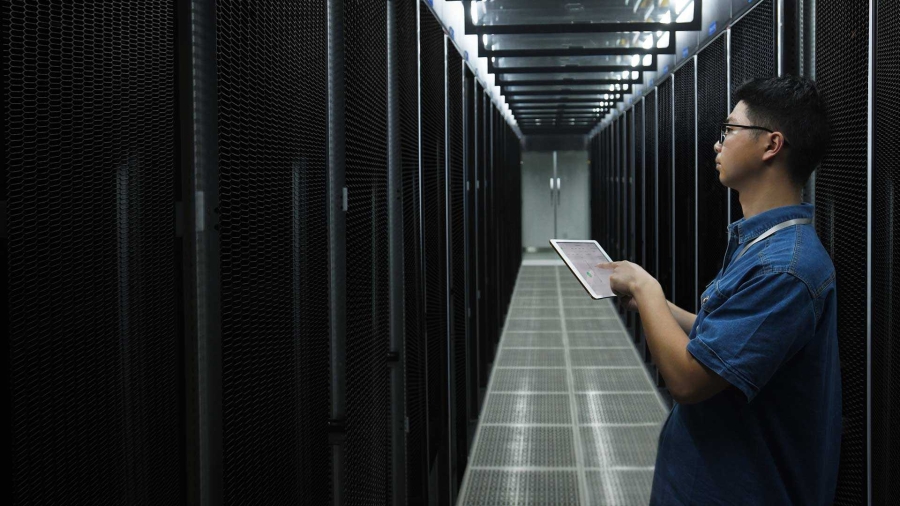 boy with tablet works in data center