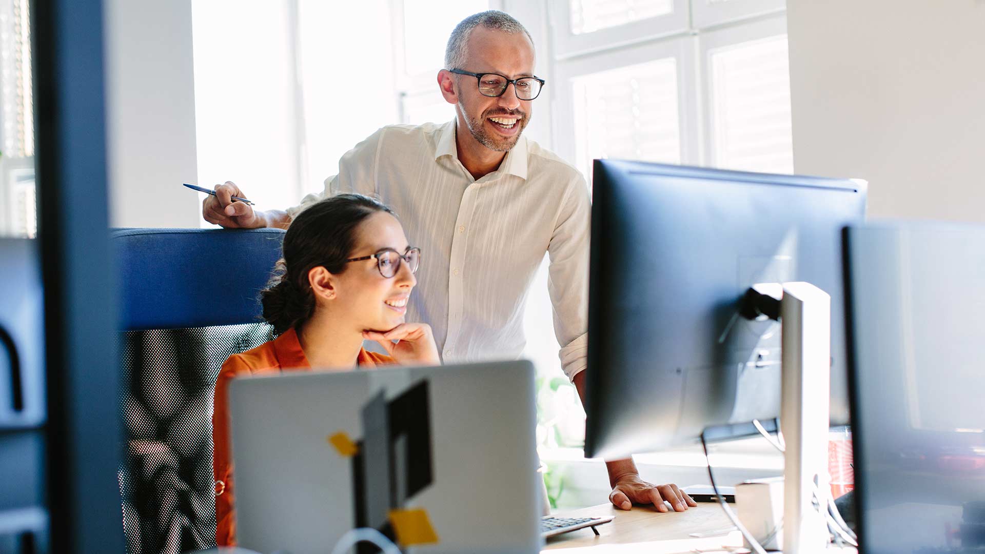 Two employees discussing in office