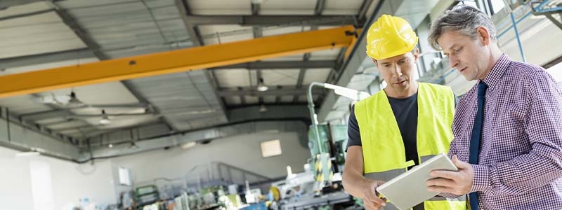 A person wearing a safety vest and hard hat