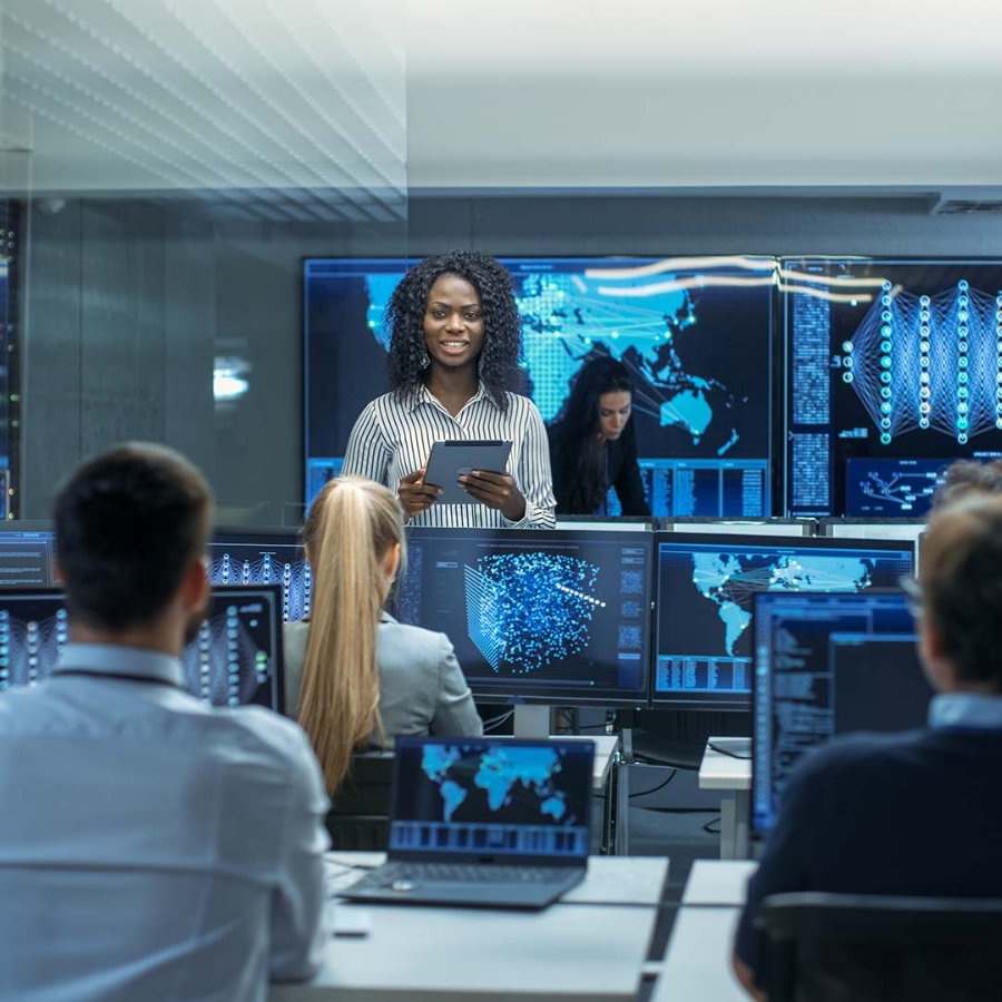 A person standing in front of several computers