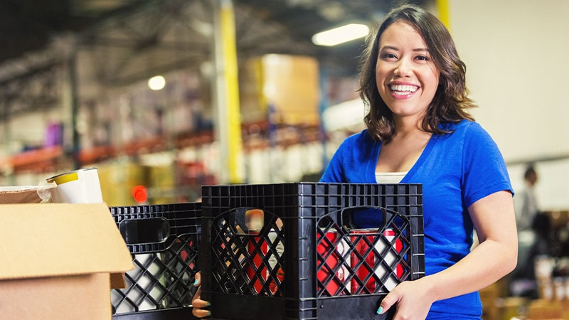 A person carrying a couple of crates