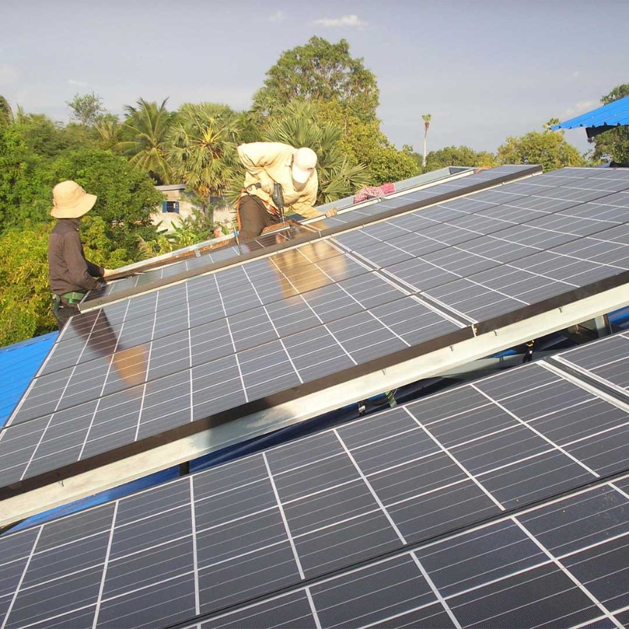 A group of people working on solar panels