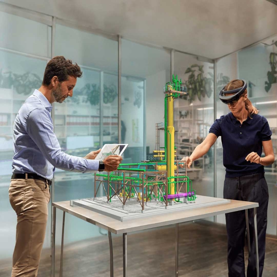 A person and person looking at a model of a structure