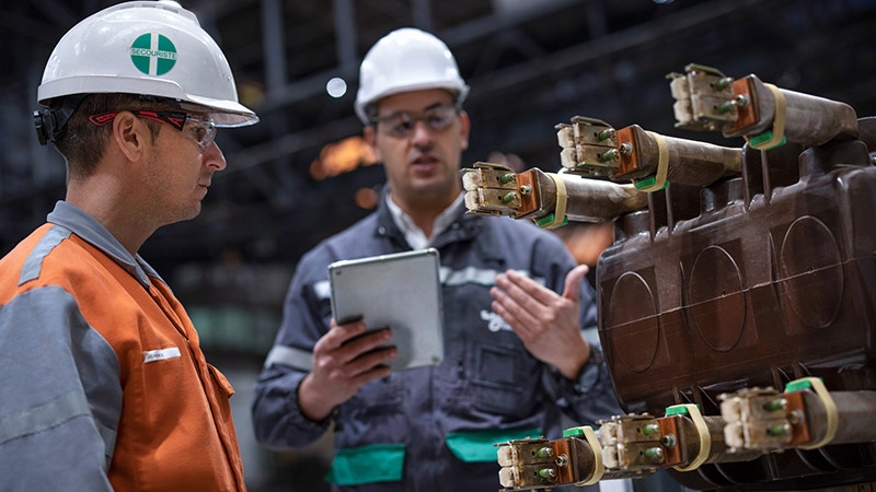 men presenting machinery tablet in hand