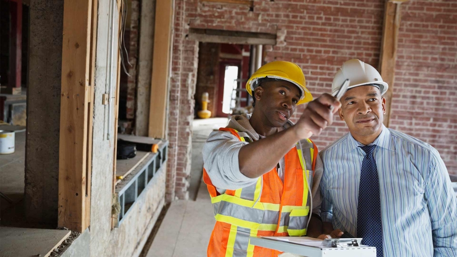 two man constructing building