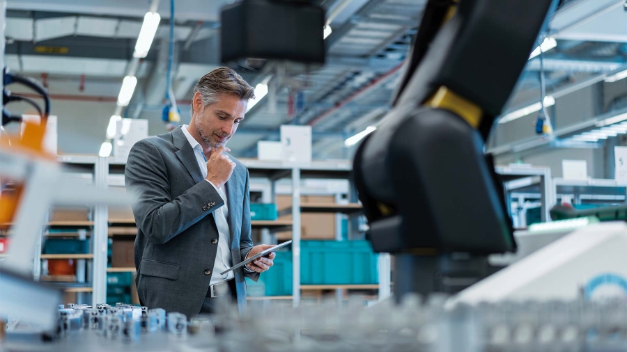 A person in a suit looking at a device