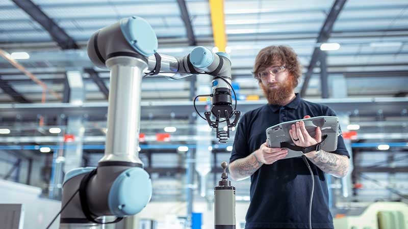 Worker operating a robot vehicle in a battery manufacturing plant