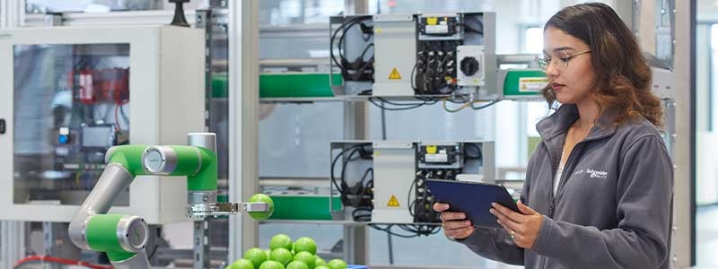 Young woman working on tablet in modern laboratory.