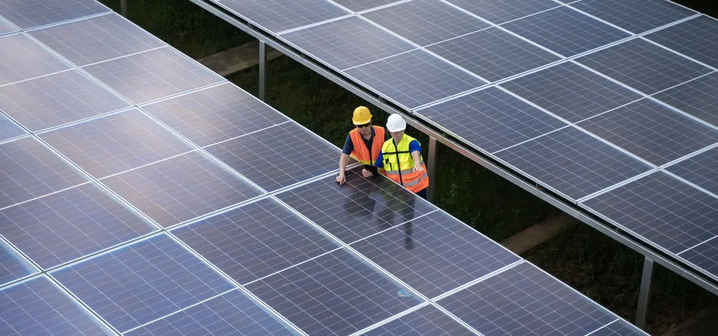 Aerial view solar energy team working at solar power station.