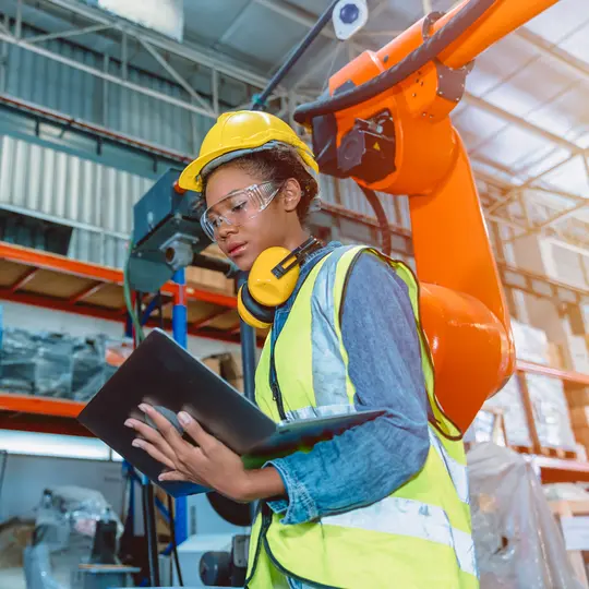 Engineer smart woman worker working programing robotic welding machine