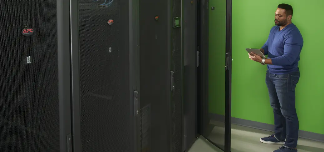 A small data center room with a specialist in the back controlling devices