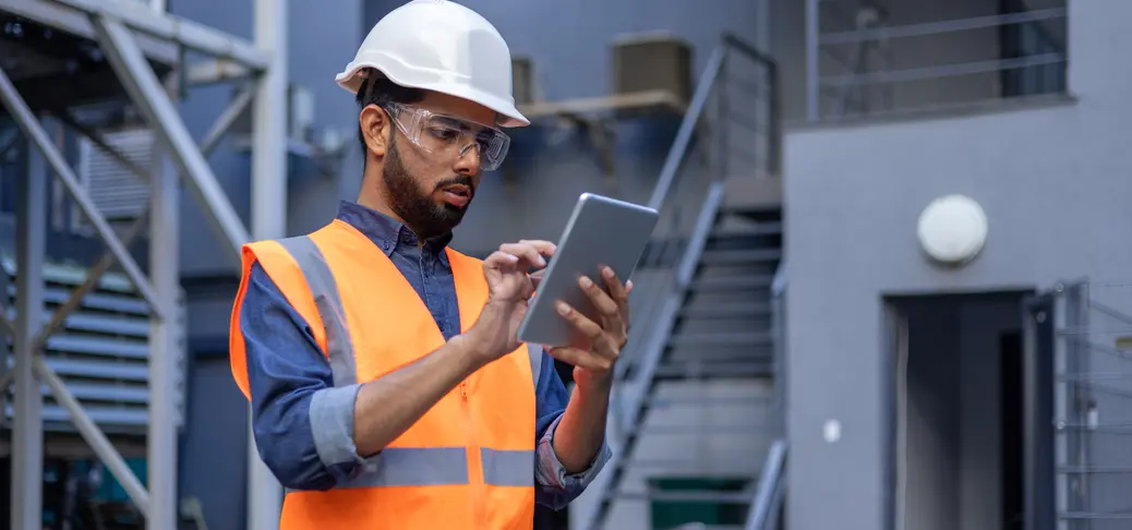 Man using tablet computer reading diagram