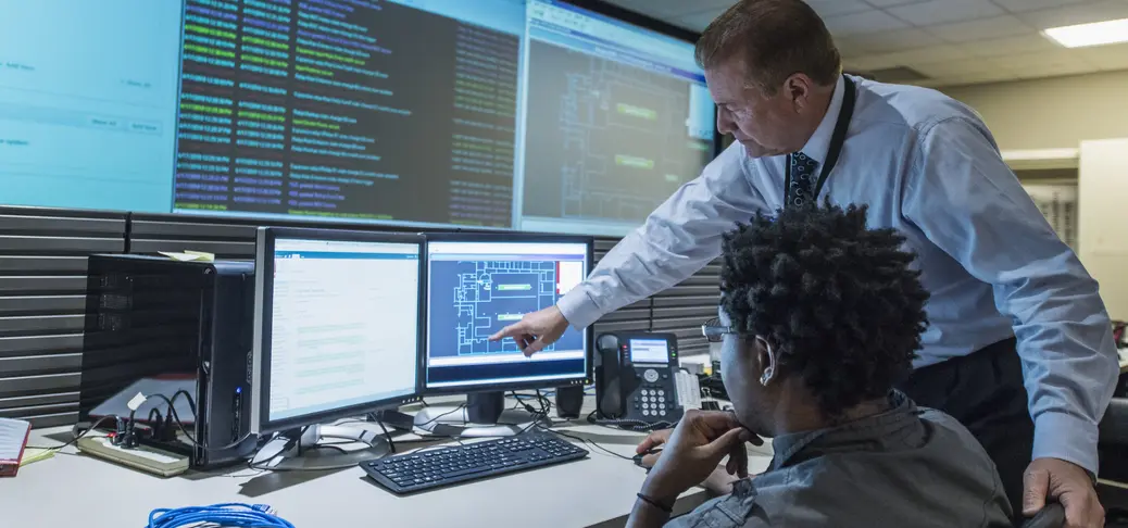 Colleagues working together in server control room