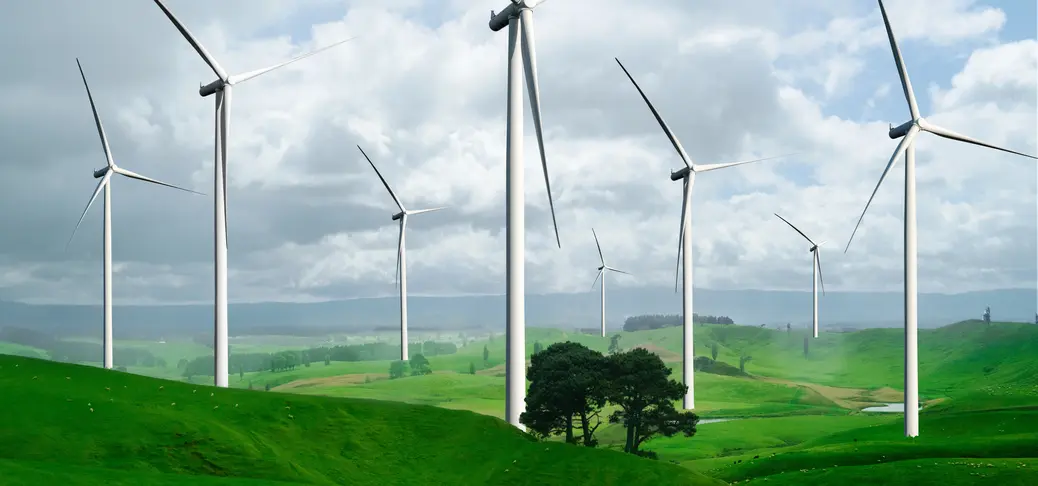 Wind turbine farm power generator in beautiful nature landscape for production of renewable green energy 