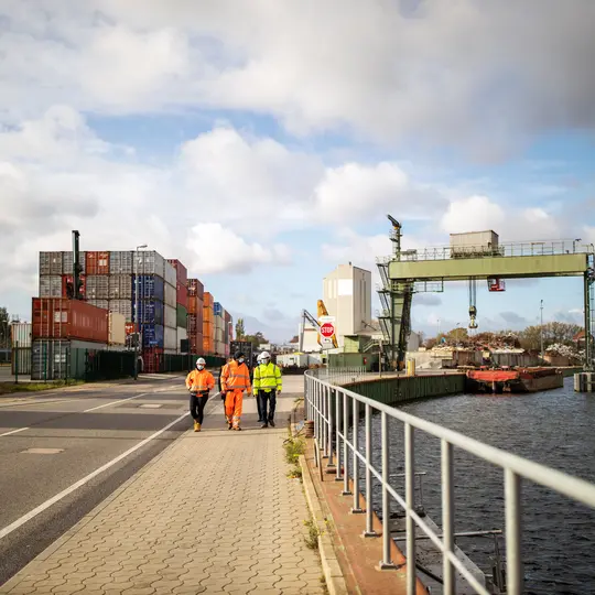 Commercial dock jetty with employees walking along the road