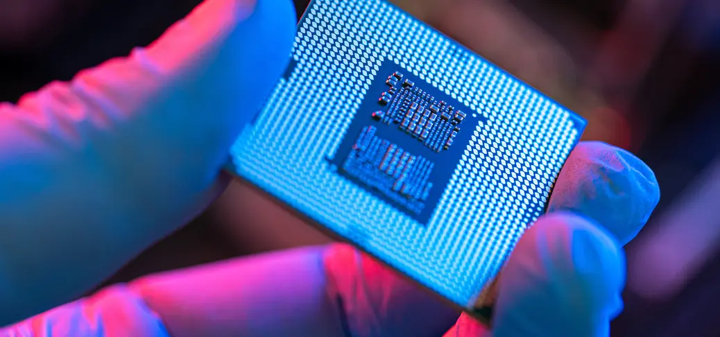 Close-up of person holding computer chip