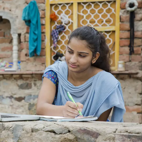 A girl in India working on her laptop.