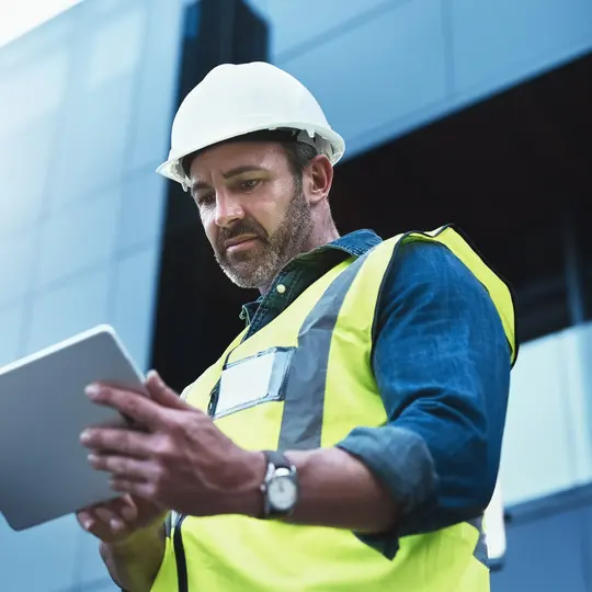 A panel builder looking at a tablet and getting to know e-guide