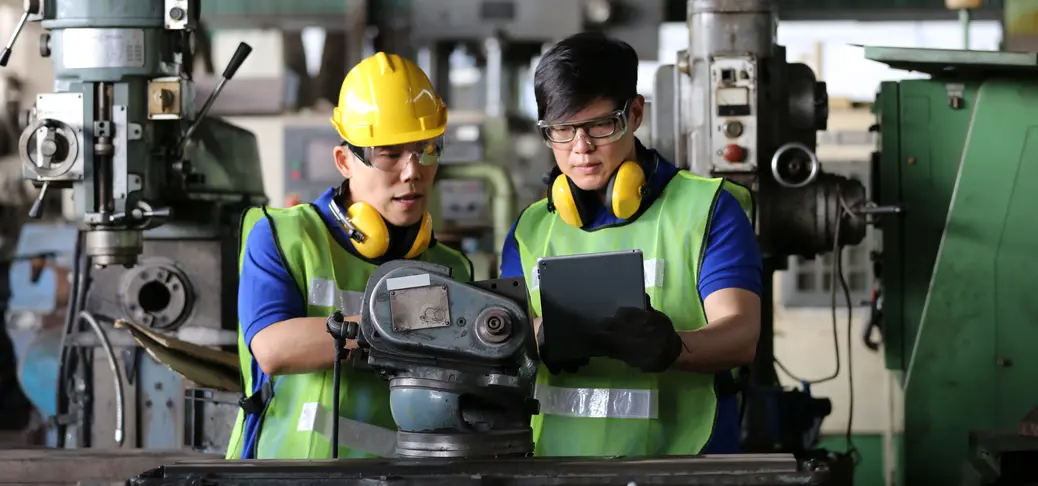 Two experts reviewing the settings of insulation monitoring devices