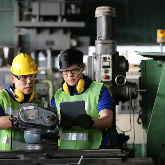 Two experts reviewing the settings of insulation monitoring devices