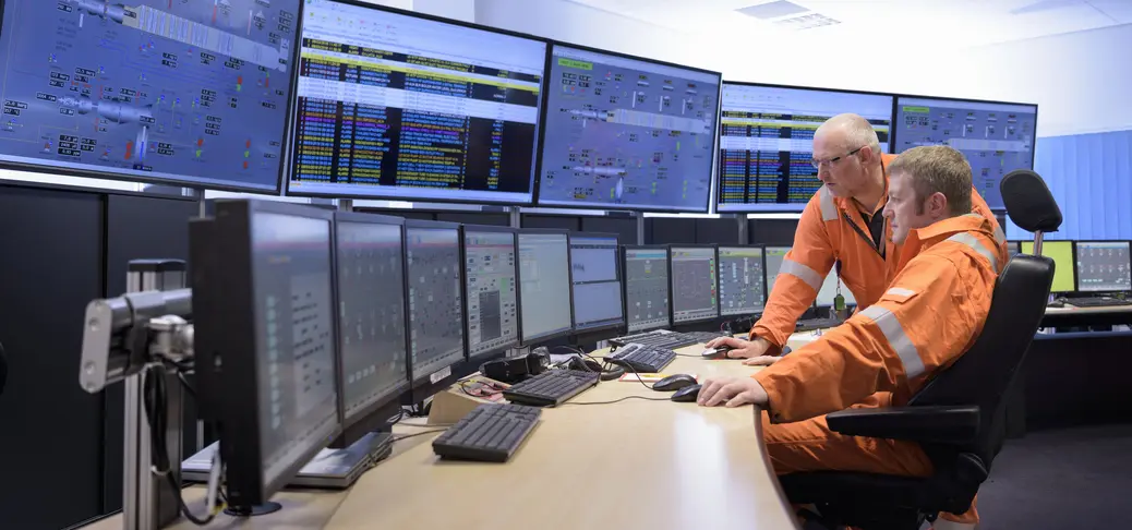 Experts in a control room monitoring power safety at sea