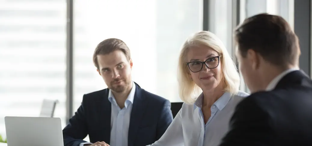 Woman and man laugh and discuss how a partnership with industrial automation services helped with their businesses.