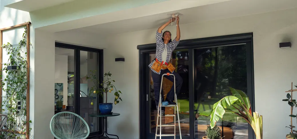 Female specialist performing maintenance tasks following electrical safety standards