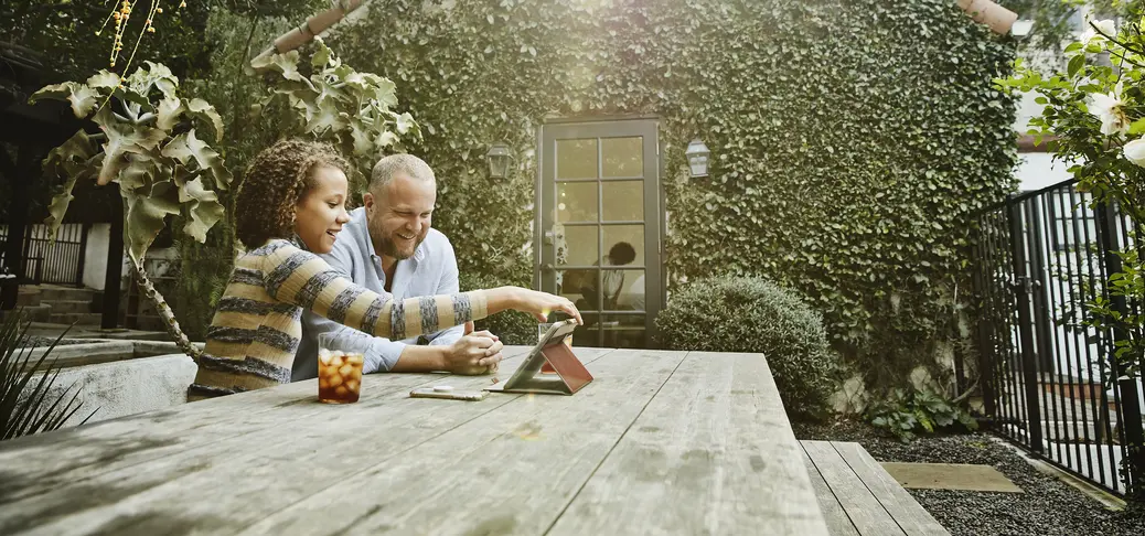 Smiling father and daughter looking at the tablet