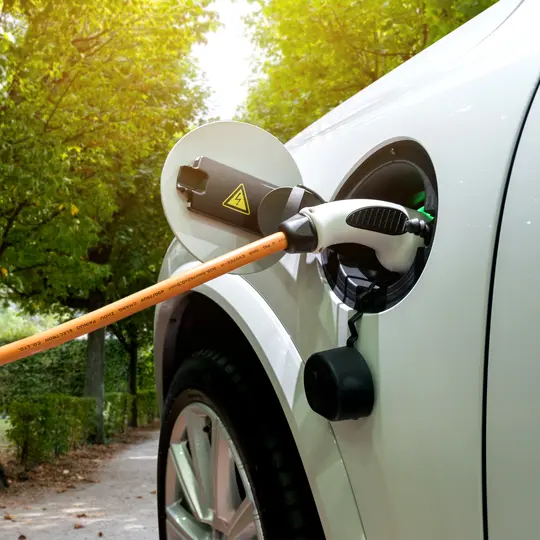 Charging an electric car with the power cable supply plugged in